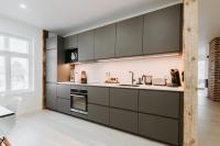 a kitchen with gray cabinets and a window at Luxury 2BR Apartment in Haapsalu Old Town in Haapsalu