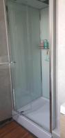 a shower with a glass door in a bathroom at Résidence Auger in Bourges