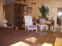 a bedroom with two chairs and a table and a plant at Un havre de paix in Aigues-Vives