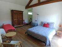 a bedroom with a bed and a table and chairs at 2 chambres privées au calme à la Maison des Bambous in Dijon