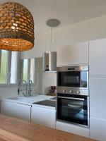 a kitchen with a stainless steel oven and a sink at Belle vue sur mer, très près du port de Sanary in Sanary-sur-Mer