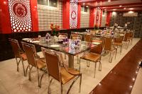 a row of tables and chairs in a restaurant at HOTEL GM INTERNATIONAL in Bodh Gaya