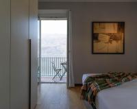A bed or beds in a room at Mamma Ciccia Holiday Home - Sunset Balcony