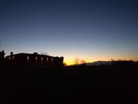 The sunrise or sunset as seen from a vendégházakat or nearby