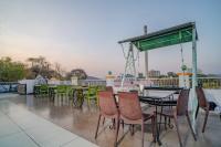 a group of tables and chairs on a roof at Hotel Ambavgarh Palace in Udaipur