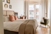 a bedroom with a bed and a chair and a window at Fritiden Hotell &amp; Kongress in Ystad