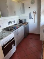 A kitchen or kitchenette at Ferienhaus Panorama, San Teodoro, Isuledda