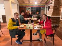 a group of people sitting at a table eating food at Mateospaxi in Machachi