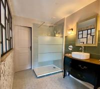 a bathroom with a shower and a sink and a tub at Maison Alfred et Agatha in Pleudihen-sur-Rance