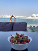 a bowl of strawberries on a table with a couch at منتجع اووه يامال البحري في الخيران OOh Yaa Mal in Al Khīrān