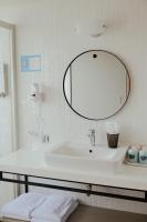 a bathroom with a white sink and a mirror at Light Hostel - Tainan in Tainan