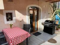 a patio with a table and a grill on a porch at historic authentic atmosphere - high-end luxury décor in Le Cannet