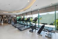 a gym with a row of treadmills and ellipticals at Chatrium Hotel Riverside Bangkok in Bangkok