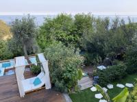 an aerial view of a garden with chairs and trees at Charming bedroom in luxurious villa with seaview in Éze
