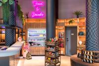 a beauty shop with a pink sign on the wall at Moxy The Hague in The Hague