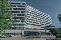 a large building with a parking lot in front of it at Courtyard by Marriott Stockholm Kungsholmen in Stockholm