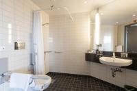 a bathroom with a toilet and a sink at Courtyard by Marriott Stockholm Kungsholmen in Stockholm