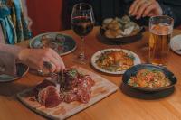 a table with plates of food and glasses of wine at Courtyard by Marriott Stockholm Kungsholmen in Stockholm