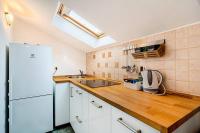 a kitchen with a white refrigerator and a wooden counter top at Apartments by the sea Cres - 8095 in Cres