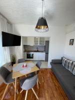 a living room with a table and a couch at Apartman ANA in Vrlika
