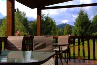 a patio with a table and chairs on a porch at Схили Карпат in Rozhanka Nizhnyaya