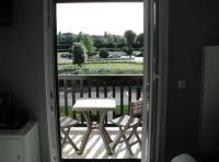 a view of a table and chairs from a door at 2 pièces ensoleillé accès direct plage in Cabourg