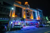 a building with neon lights on a street at night at Wenpin Hotel - Pier 2 in Kaohsiung
