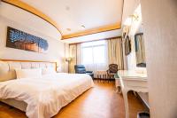 a hotel room with a bed and a desk at Wenpin Hotel - Pier 2 in Kaohsiung