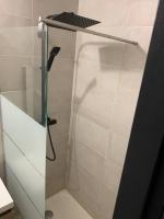 a shower with a glass door in a bathroom at Appartement équipé pour 5 pers in Vénissieux