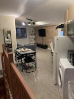 a kitchen and dining room with a table and a refrigerator at Appartement équipé pour 5 pers in Vénissieux