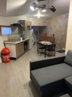 a kitchen and a living room with a couch and a table at Appartement équipé pour 5 pers in Vénissieux