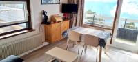 a dining room with a table and chairs and a window at Appartement d&#39;une chambre avec vue sur la ville balcon et wifi a Chamrousse in Chamrousse