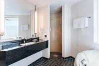 a bathroom with a sink and a toilet at Courtyard by Marriott Stockholm Kungsholmen in Stockholm