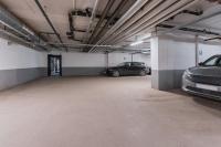 a parking garage with two cars parked in it at Courtyard by Marriott Stockholm Kungsholmen in Stockholm