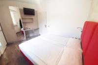 A bed or beds in a room at Hotel Da Tino