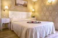 a bedroom with a bed with a tray of food on it at Residenza Goldoni in Venice