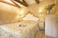 a bedroom with a bed with a tray of food on it at Residenza Goldoni in Venice