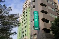 a tall building with a sign in front of it at CHECK inn Express Taichung Fengchia in Taichung