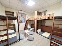 a room with three bunk beds and a table at Star-Moon B&amp;B Green Island in Green Island