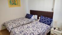 A bed or beds in a room at BEACHFRONT -- NEW LUXURY Apartment -- 1ª Linea Playa -- Fuengirola CITY CENTER -- Private PARKING -- Panoramic Sea Views --