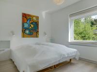 a white bedroom with a bed and a window at Holiday Home Bjarne - 1-2km from the sea in Sealand by Interhome in Tisvildeleje