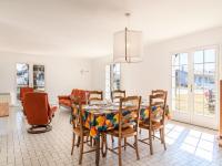 a dining room with a table and chairs at Holiday Home Les Chênes by Interhome in Lit-et-Mixe