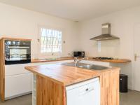 a kitchen with a wooden counter top and a sink at Holiday Home Les Chênes by Interhome in Lit-et-Mixe