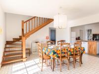 a kitchen and dining room with a table and chairs at Holiday Home Les Chênes by Interhome in Lit-et-Mixe