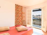a bedroom with a bed and a large window at Holiday Home Les Chênes by Interhome in Lit-et-Mixe