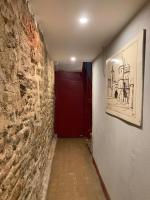 a hallway with a red door and a brick wall at Appart de style centre Sedan 2E in Sedan