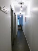 a hallway with white walls and a long hallway at Appart de style centre Sedan 2E in Sedan