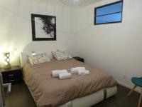 a bedroom with a large bed with two pillows at Appart de style centre Sedan 2E in Sedan