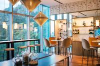 a restaurant with tables and chairs and large windows at Hotel Bellevue Dubrovnik in Dubrovnik