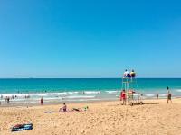 a group of people on a lifeguard tower on a beach at Holiday Home Le chant des milans by Interhome in Ondres